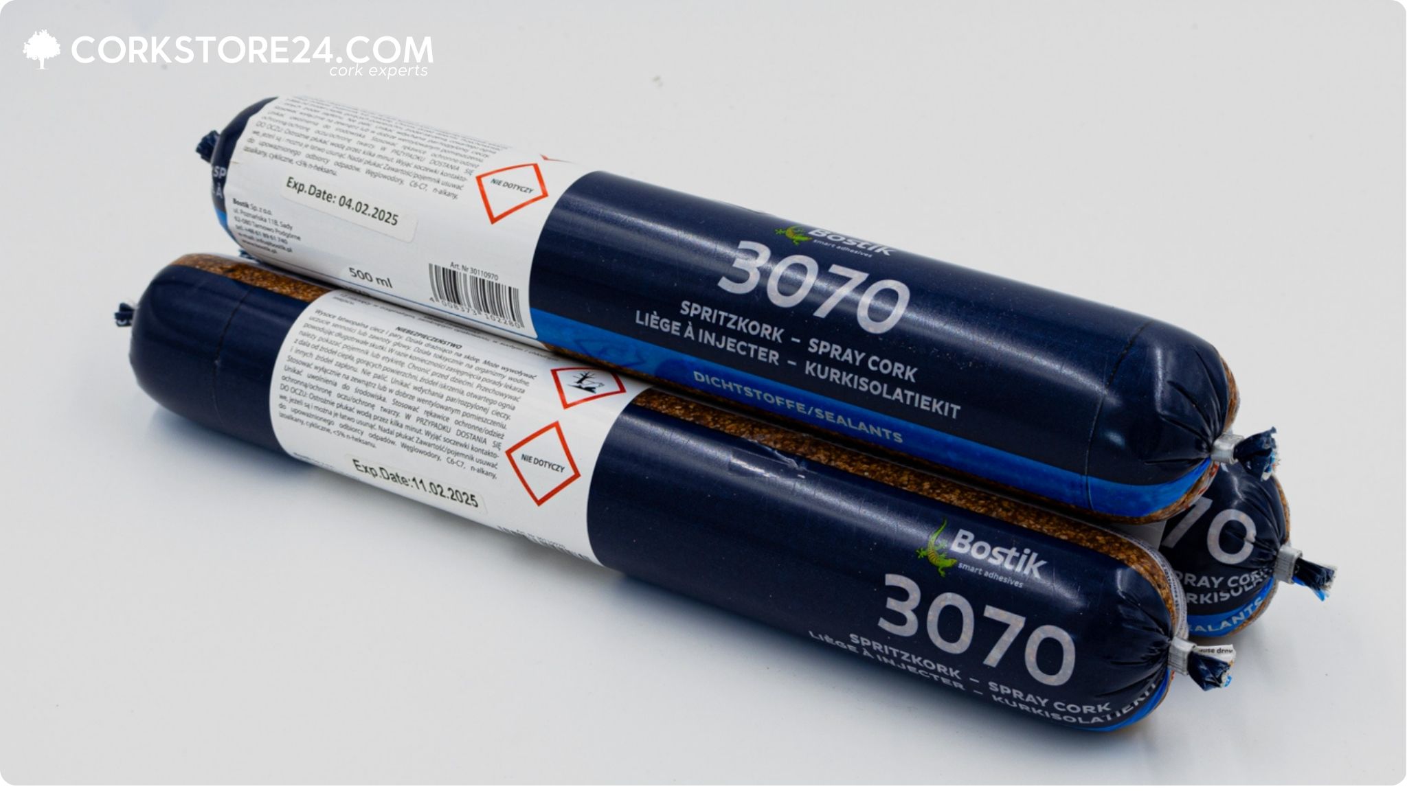 Two tubes with blue and white labels, branded Bostik spritzkork 3070. One of the tubes is opened, showing the cork inside.